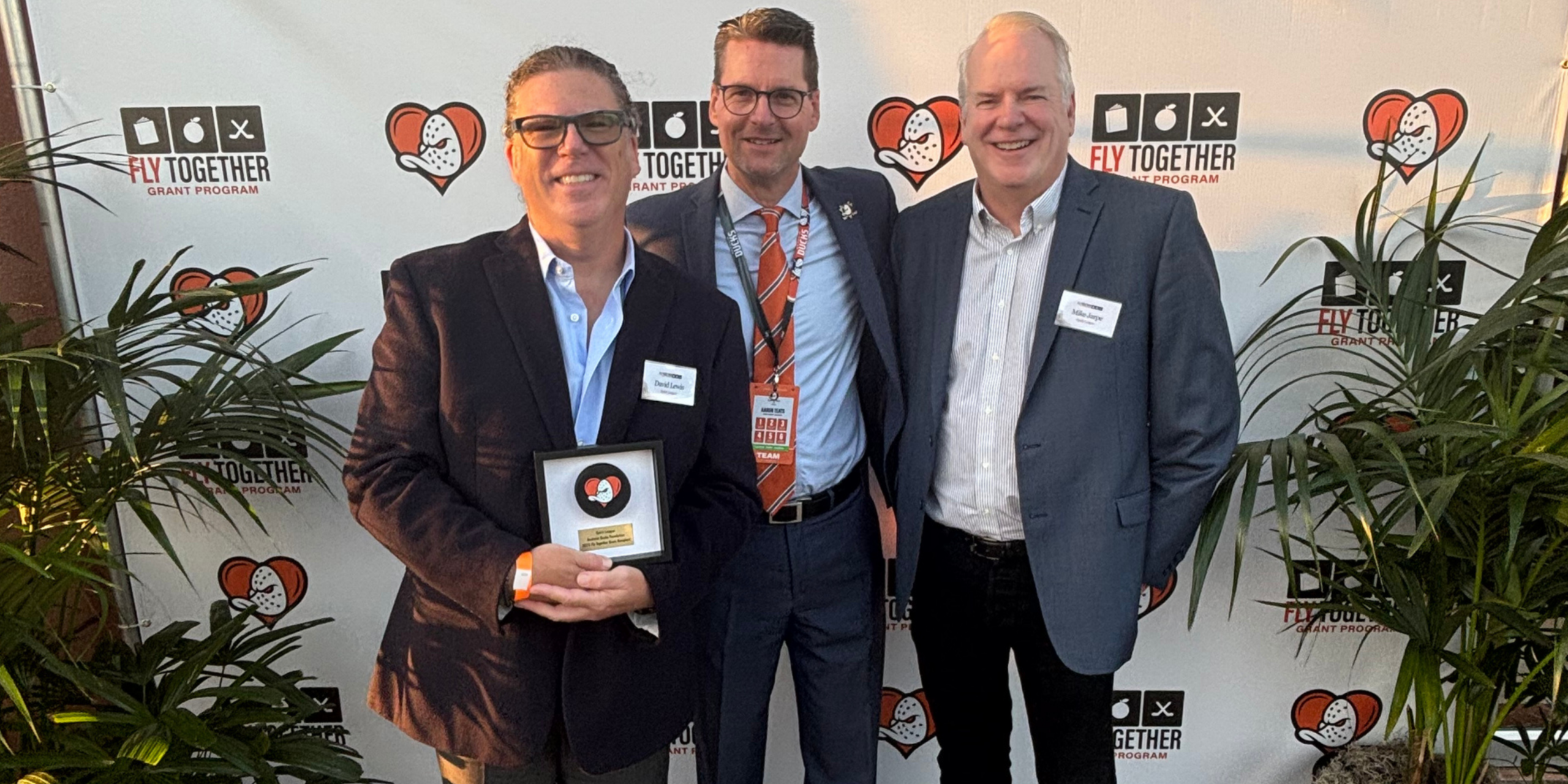 Anaheim Ducks honor 2025 Executive Director David Lewis and Board Member Mike Jarpe receiving the Anaheim Ducks Fly Together grant award in Fall 2025